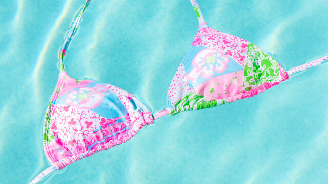 Colorful triangle bikini top floating in pool